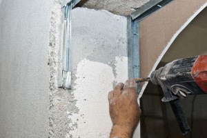 Fastening the metal stud frame to the wall