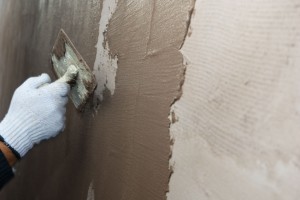 Applying putty to polystyrene sheets insulation