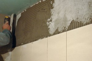 Installing last row of tile in bathroom