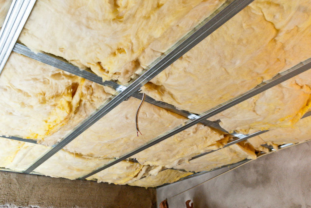 Installing insulation between metal stud frame