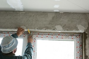Securing metal corner bead with finish plaster Securing metal corner bead with finish plaster