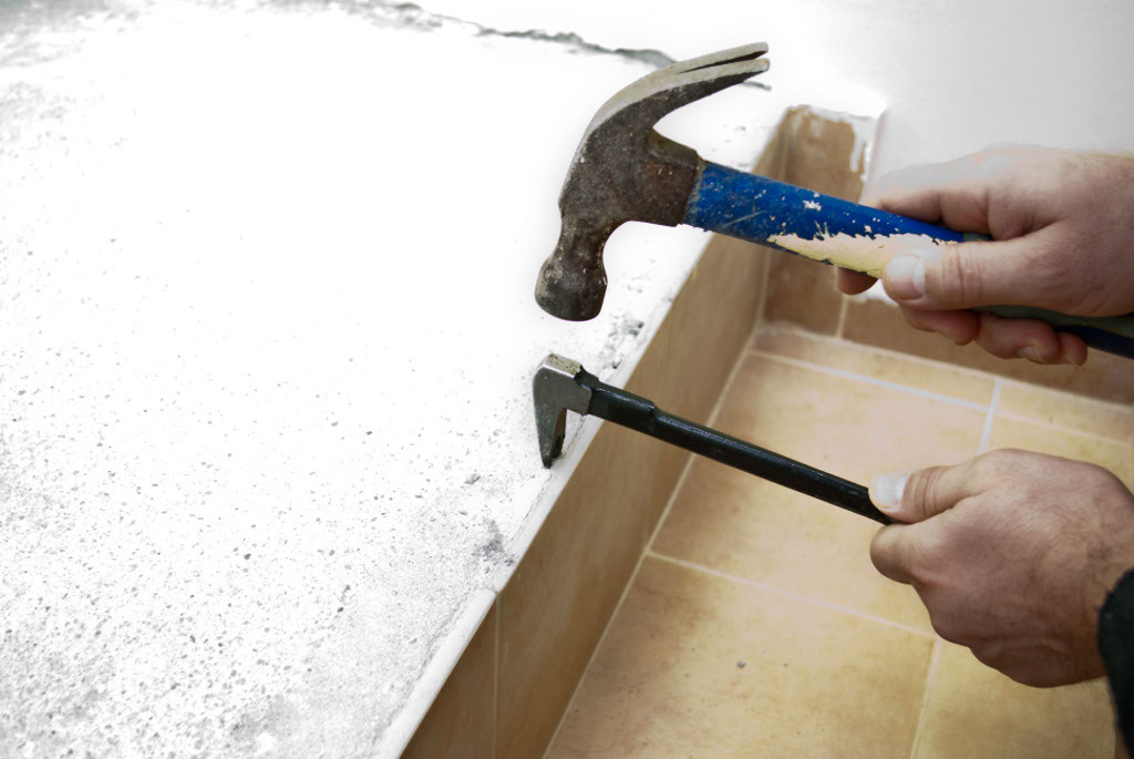 Using a chisel to remove wall tile