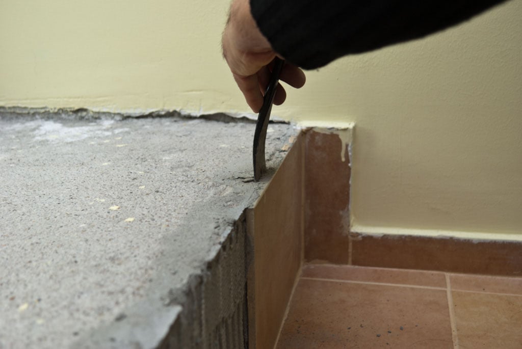 Removing ceramic tile with a chisel