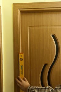 Making sure door casing is plumb