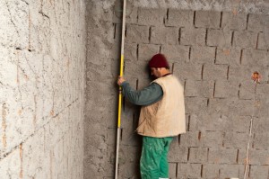 Making sure the plaster is plumb Making sure the plaster is plumb