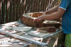 Laying bricks on wood fired pizza oven Laying bricks on wood fired pizza oven