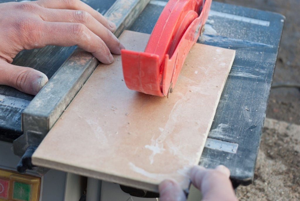 Using a wet saw to cut tiles