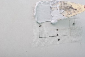 Covering the mesh tape with mud