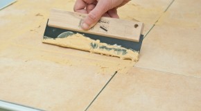 Grouting floor tiles
