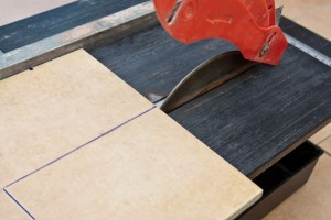 The blade goes over the cut line