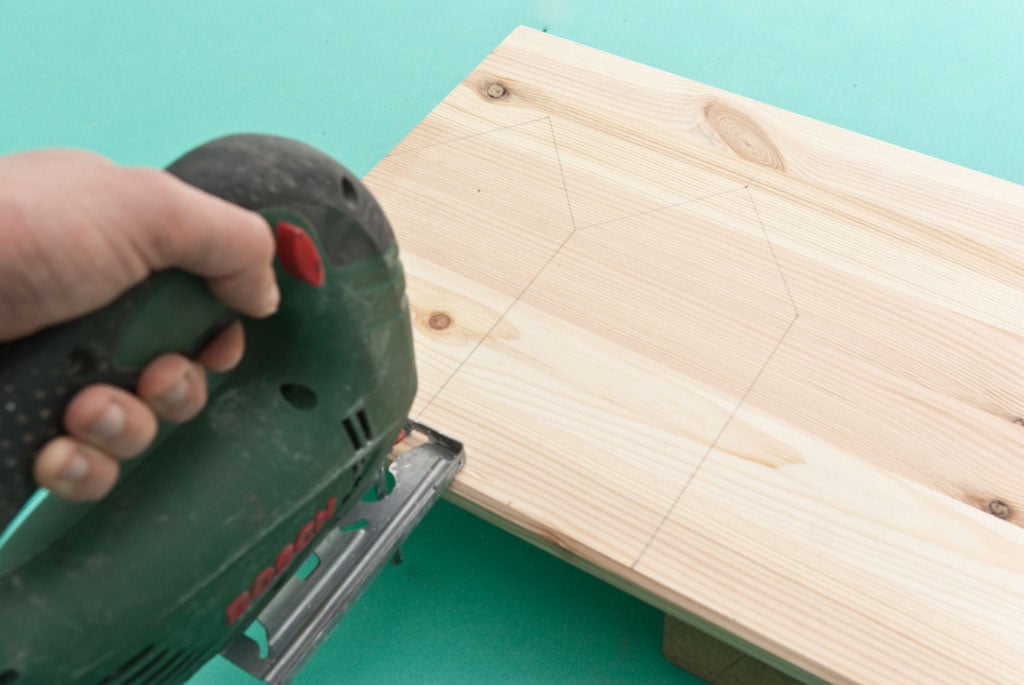 Cutting the wood boards with a jigsaw