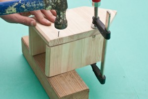 Locking together the front and sides of the birdhouse